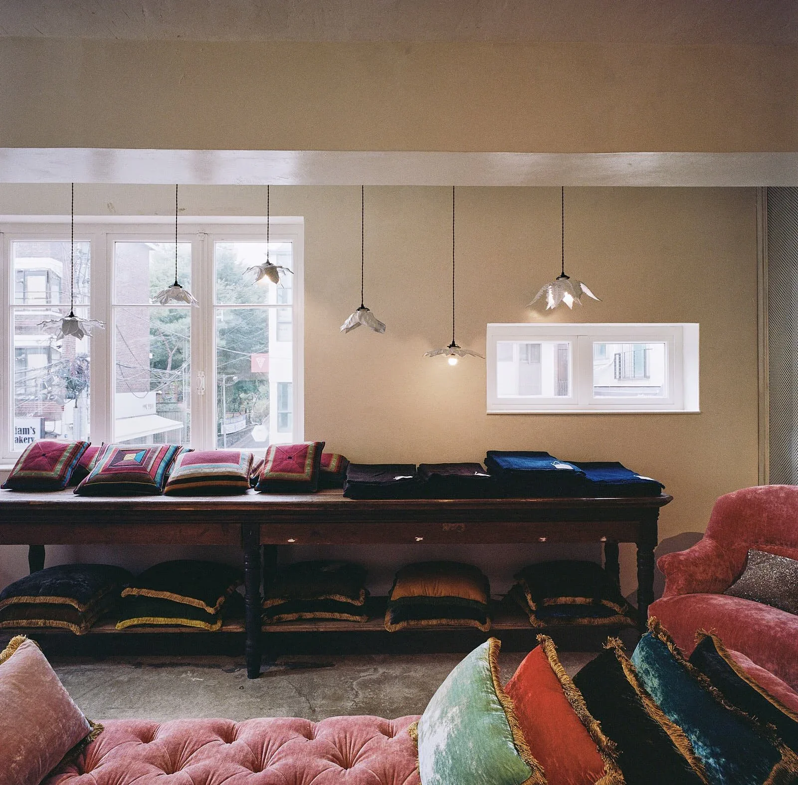 Astier de Villatte Seoul — 긴 테이블과 분홍 벨벳 좌석